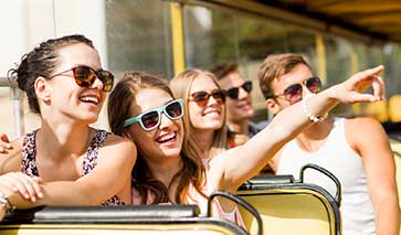 Young people with sunglasses laughing in the sunshine