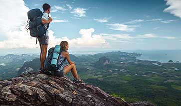 Hikers on a summit looking down towards the coast