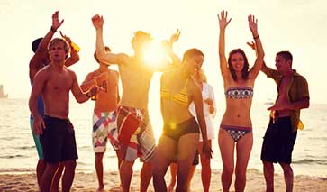 Beach party with young people dancing