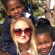 South Africa TEFL intern Megan with two of her students at school in Cape Town