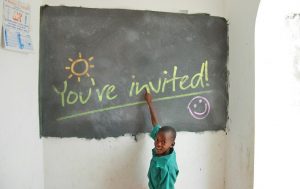 Child writing on chalkboard