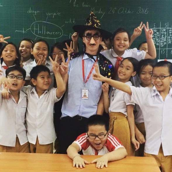 TEFL teacher in fancy dress with his class