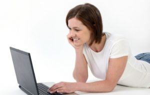 Woman smiling at laptop