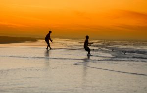 two people fishing in the sea