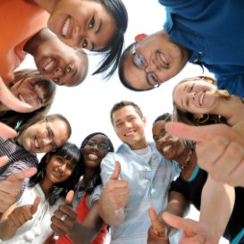 i-to-i TEFL teacher with group of pupils giving thumbs up to camera