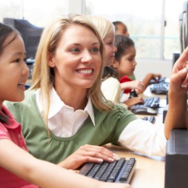 TEFL teacher and pupil working with a computer