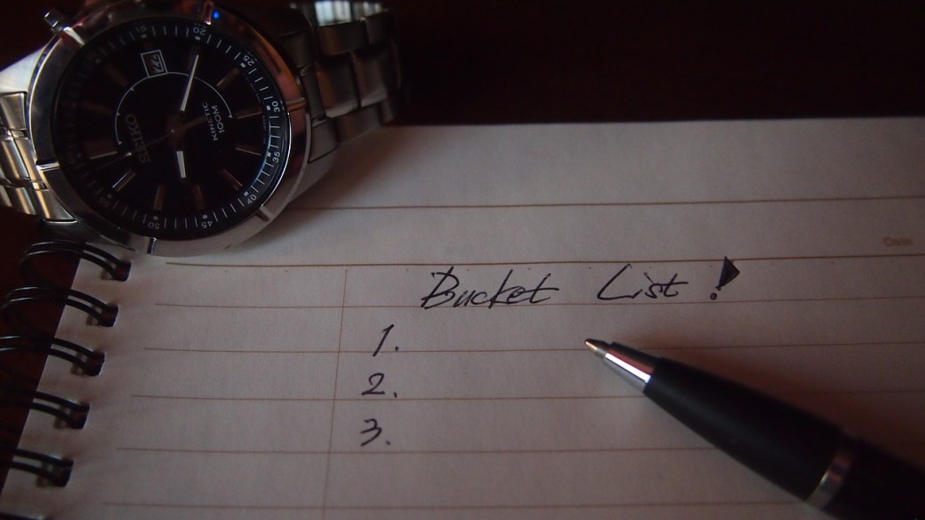 paper with pen and a watch witht he word bucket-list written down