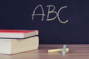 Chalkboard, books and chalk