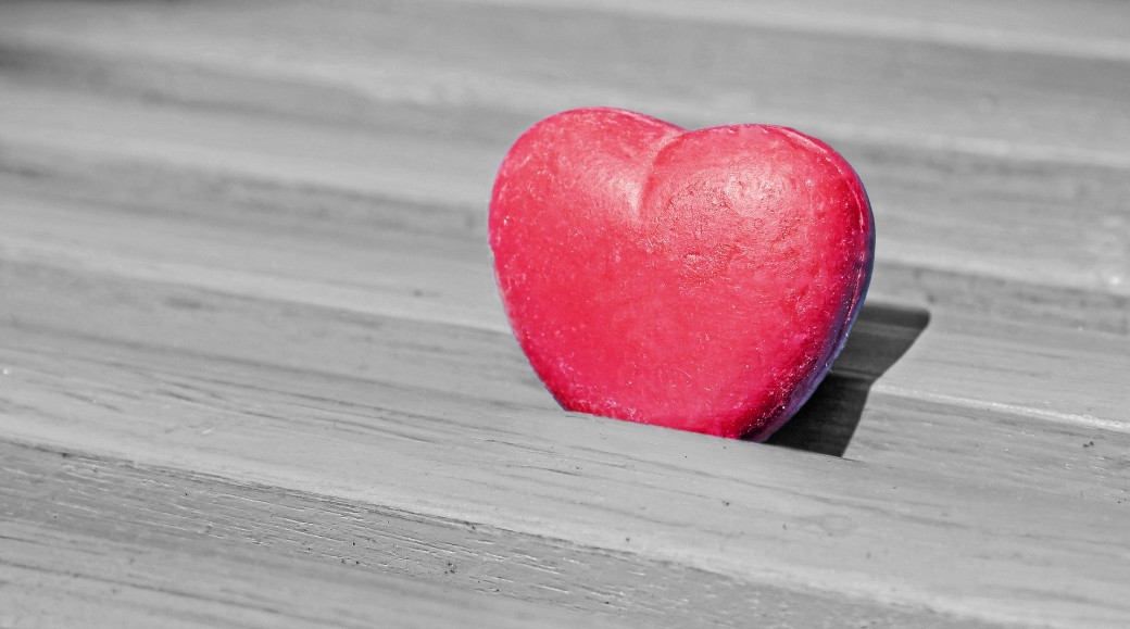 Plastic heart on a wooden bench