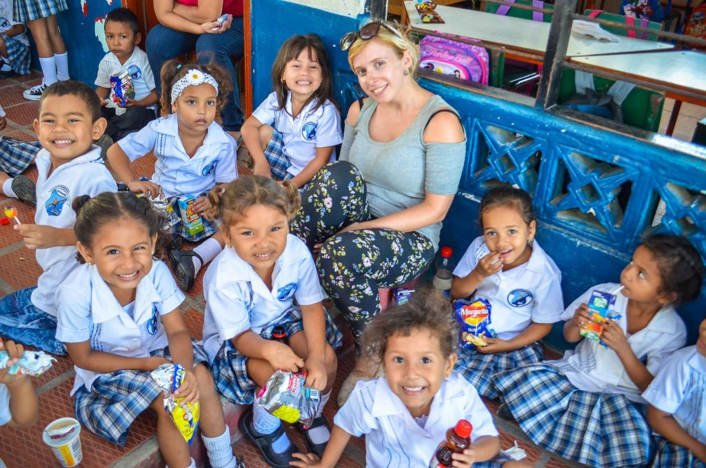 TEFL teacher surrounded by students in Colombia