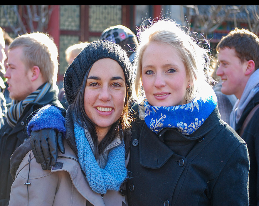 Two woman smiling abroad