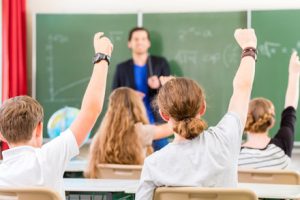 TEFL students raising their hands to ask a question