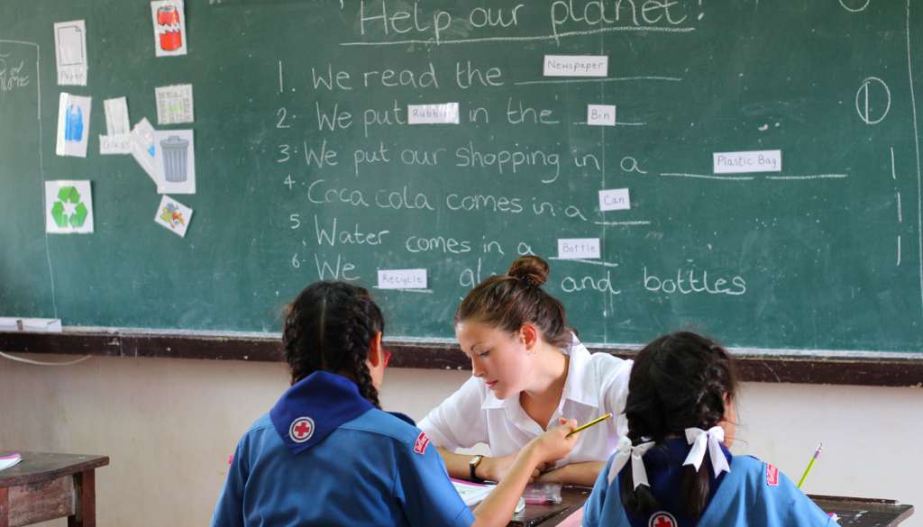 Teacher sat with students