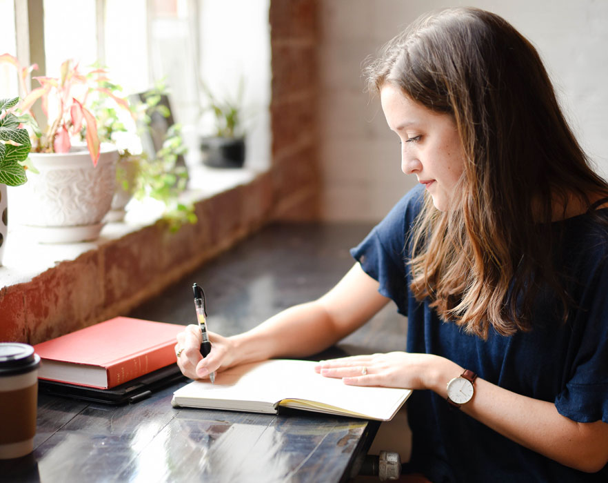 woman writing lesson plans