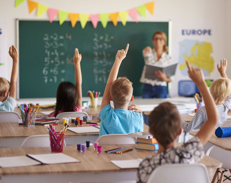 classroom with teacher answering questions