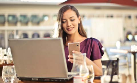 Woman on phone and laptop