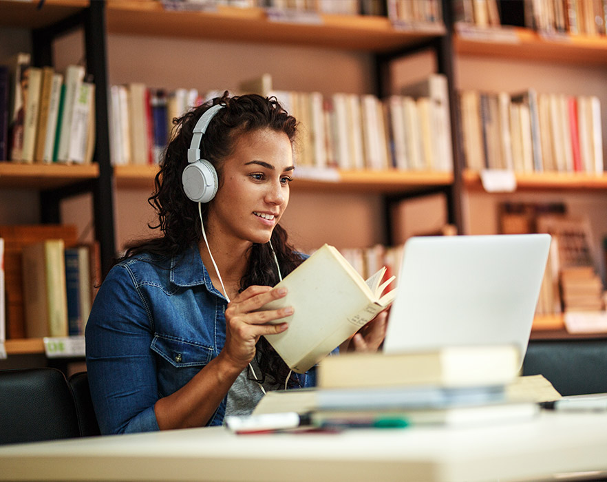 Girl on laptop in library