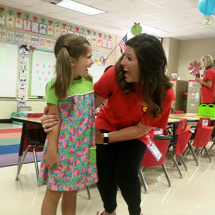 Teacher laughing with student