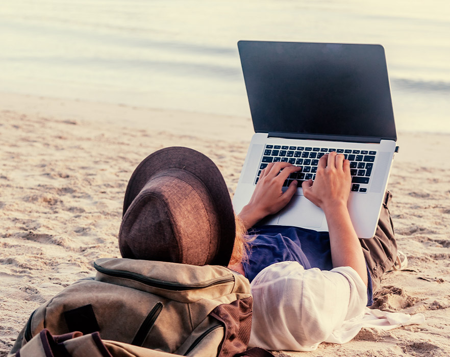 Using laptop on beach