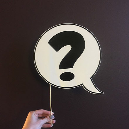 Person holding question mark sign