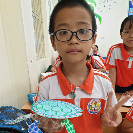 Vietnamese student with Turtle made from recycled bottles