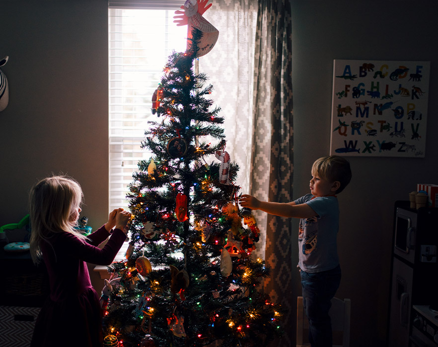 Children decorating Christmas tree