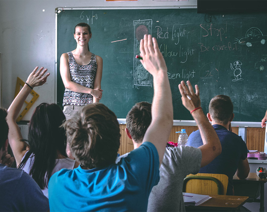 Students raising hand in class
