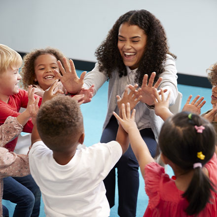 TEFL teacher high fiving students