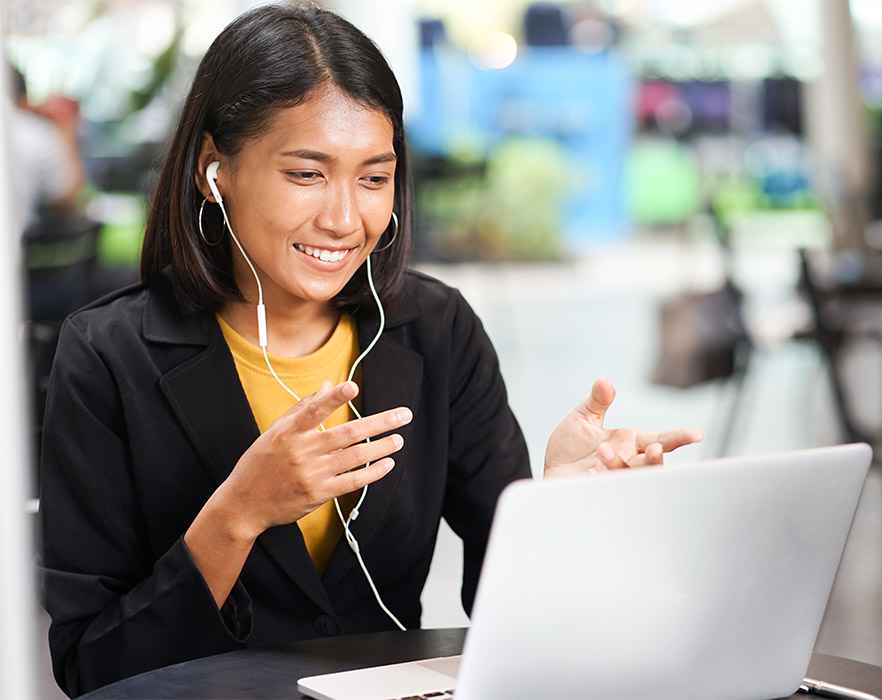 Woman teaching English online with headphones