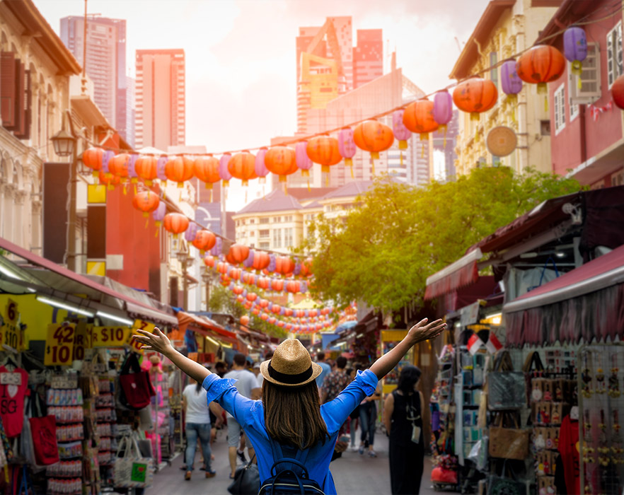 Woman with arms spread in front of market in China