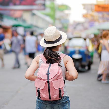 Woman with backpack on walking through streets