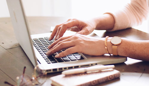 Woman typing on laptop