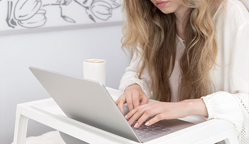 Woman typing on laptop