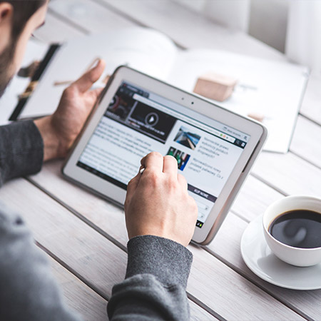 Man reading the news on a tablet