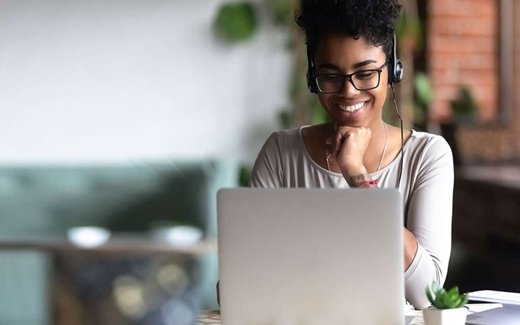 Girl with headset teaching online on her laptop