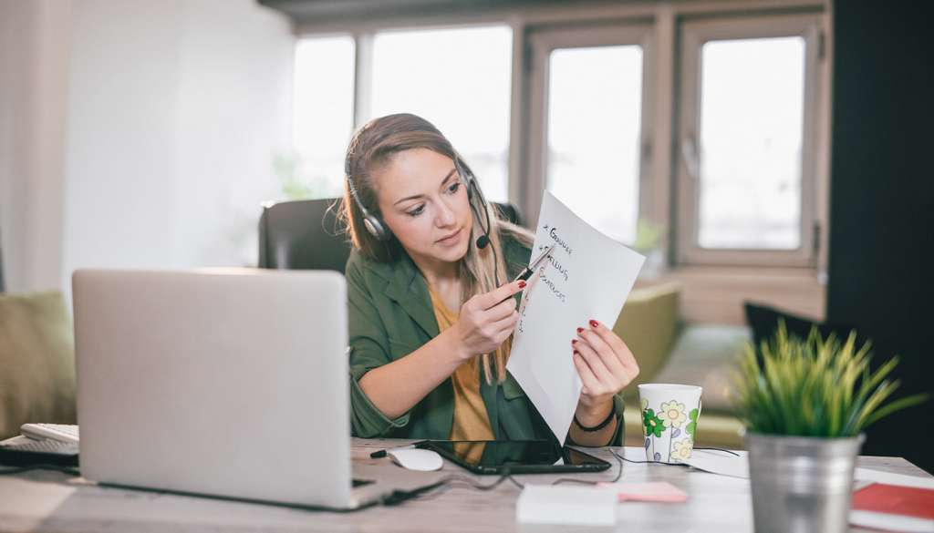 Woman teaching online using laptop