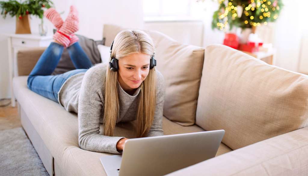 Woman using laptop on sofa