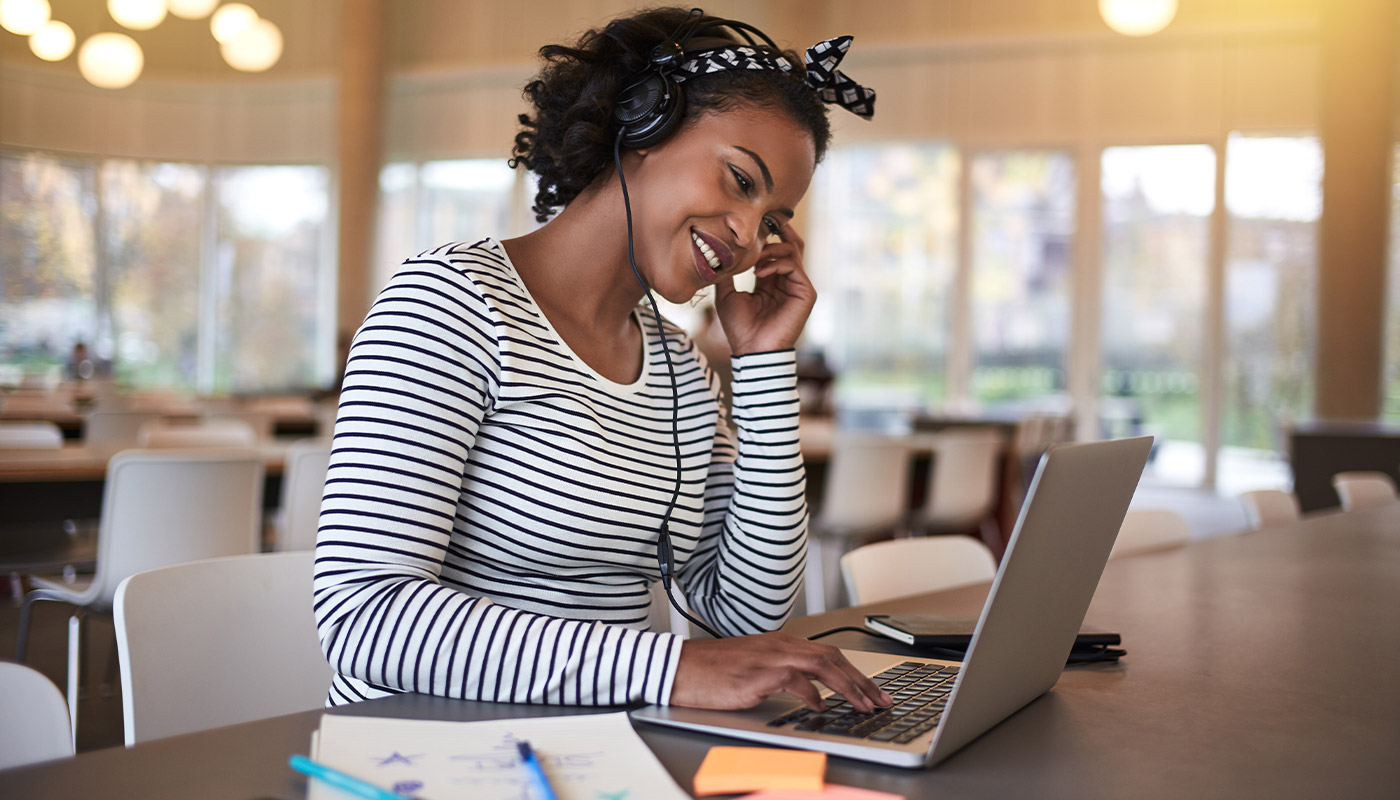 Woman using laptop with headset