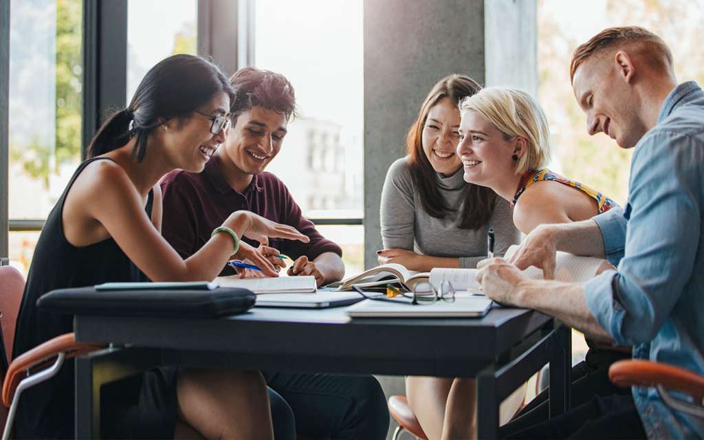 A group of people working together on assignment and having fun