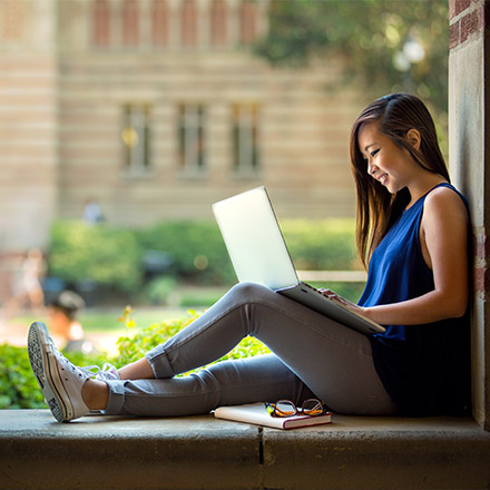 Woman sat near window on laptop