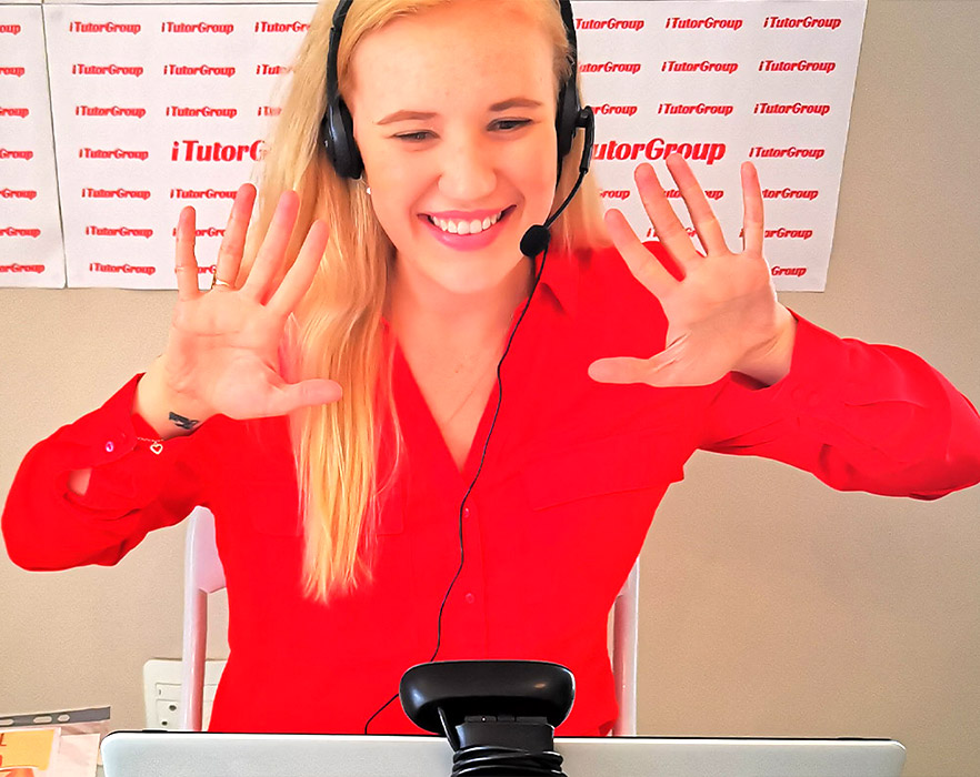 TEFL tutor Nicole smiling and waving at camera during her online English classes