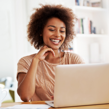 woman smiling at laptop