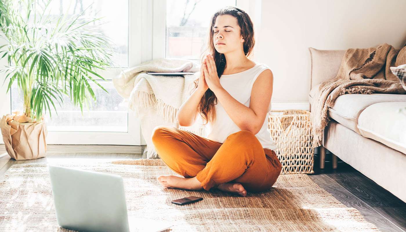 Woman learning how to do yoga online