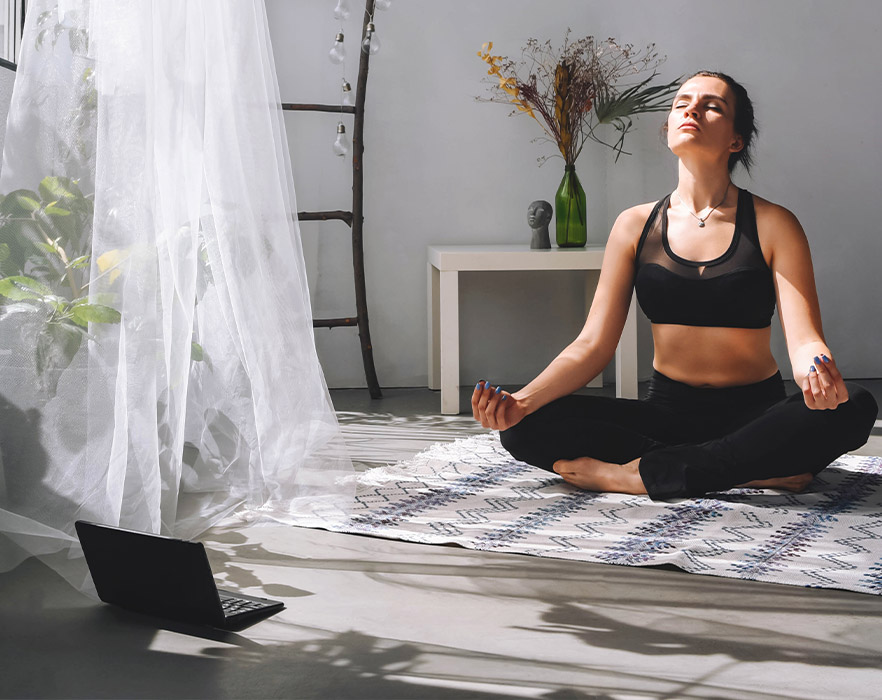 Woman learning yoga online