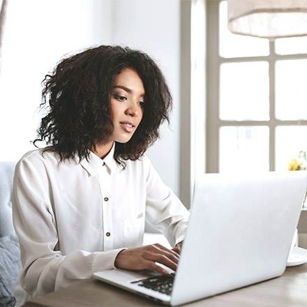 Woman sat at desk using laptop