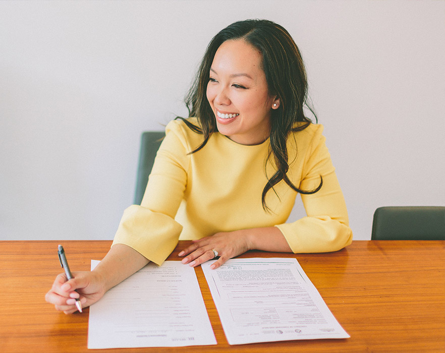 Woman sat at desk writing cv