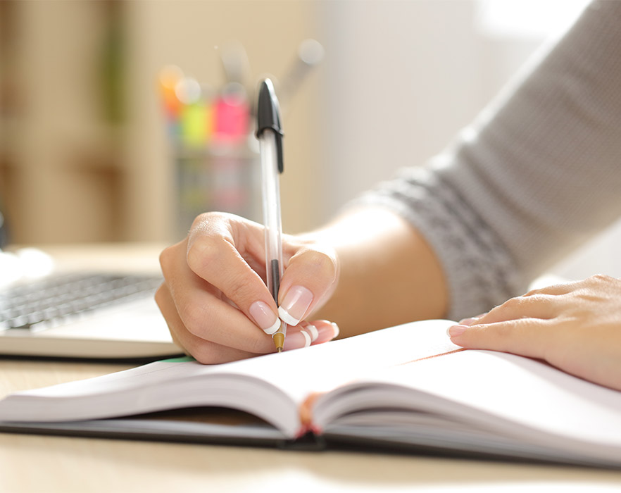 Woman writing in book