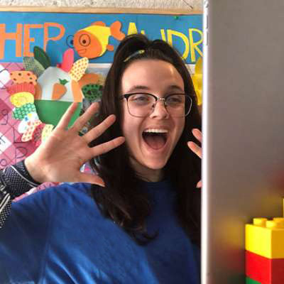 young girl making fun face to the computer