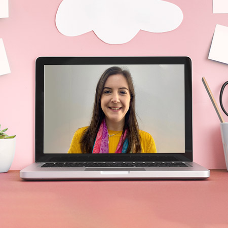 Laptop on desk with image of online TEFL tutor, Catherine