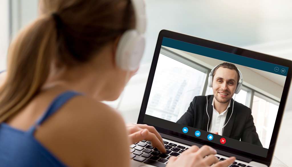 Woman using laptop to host online demo lesson